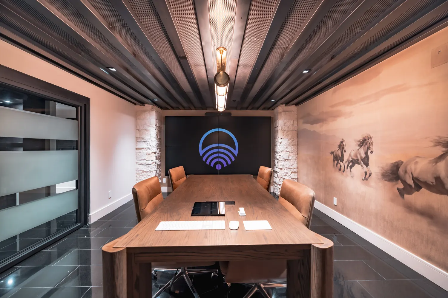 Boardroom with a video wall, stone columns and a horse mural